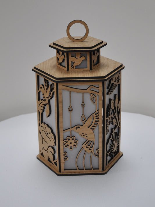 Decorative wooden lantern with intricate cut-out designs on a white background
